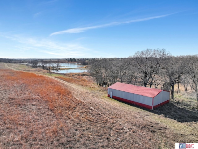 drone / aerial view featuring a rural view and a water view