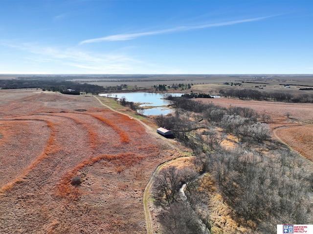 birds eye view of property featuring a water view and a rural view