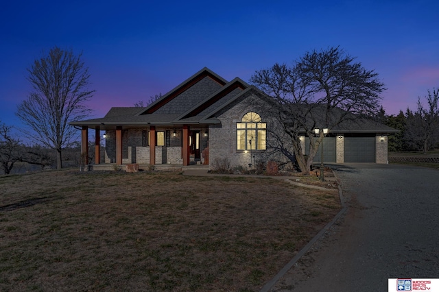 view of front of house featuring a porch and a garage