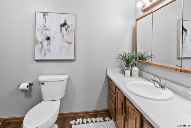 bathroom featuring hardwood / wood-style floors, vanity, and toilet