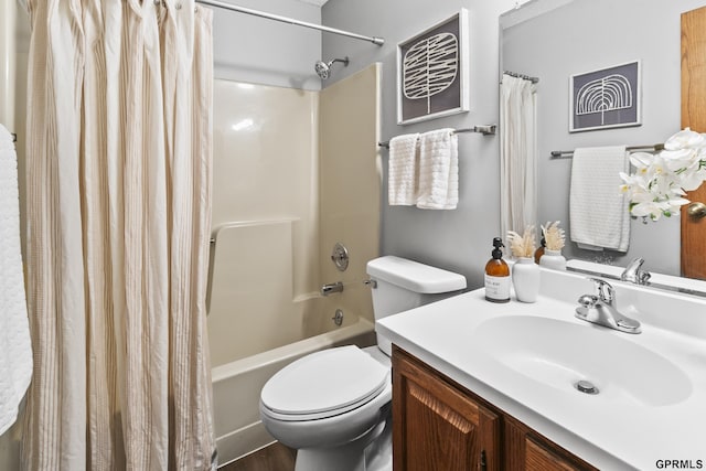 full bathroom featuring hardwood / wood-style floors, vanity, shower / bath combination with curtain, and toilet