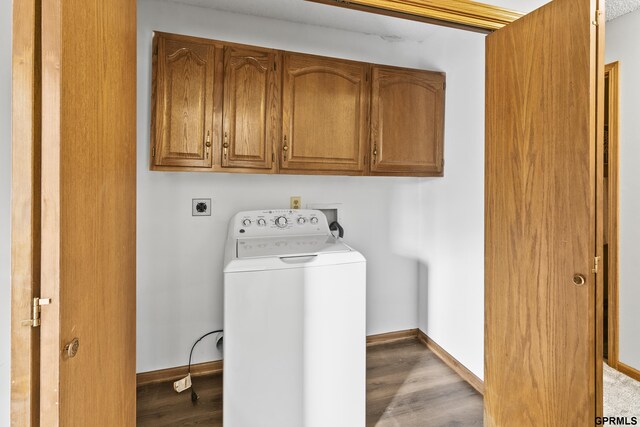 laundry area with cabinets, washer / dryer, and light wood-type flooring