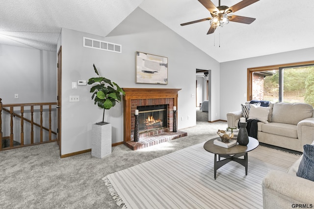 living room featuring ceiling fan, high vaulted ceiling, a textured ceiling, light carpet, and a fireplace