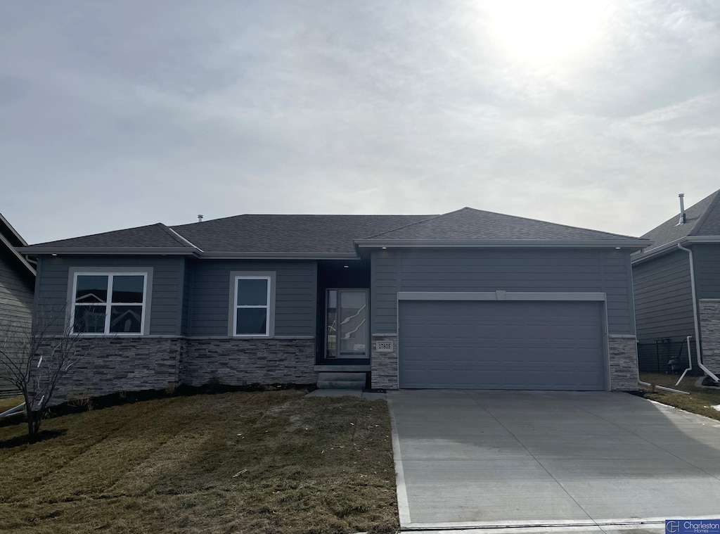 view of front of house with a garage and a front lawn