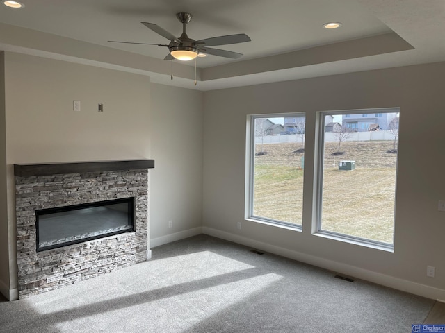 unfurnished living room with a fireplace, carpet, plenty of natural light, and ceiling fan