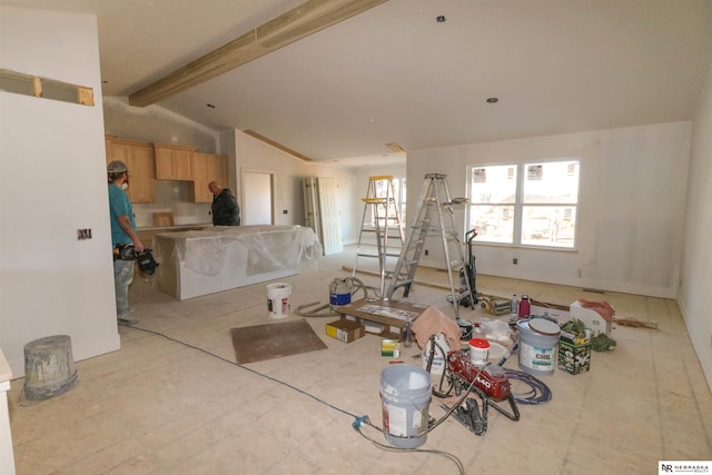 living room with lofted ceiling with beams