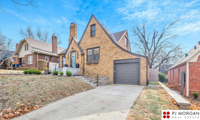 tudor house featuring a garage