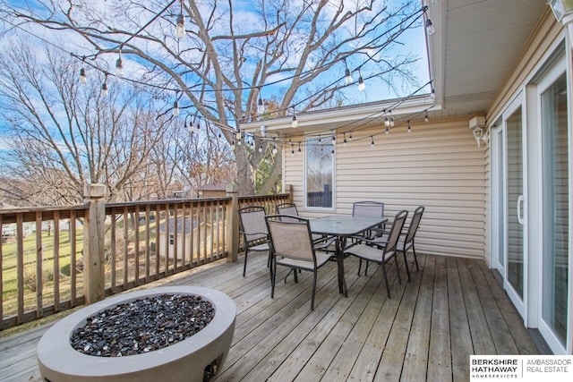 wooden terrace featuring an outdoor fire pit