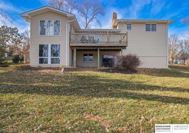 rear view of property featuring a deck and a yard