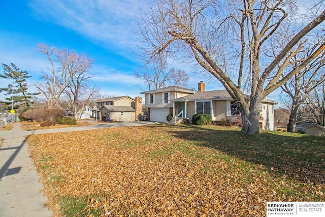 view of front of property featuring a garage and a front yard