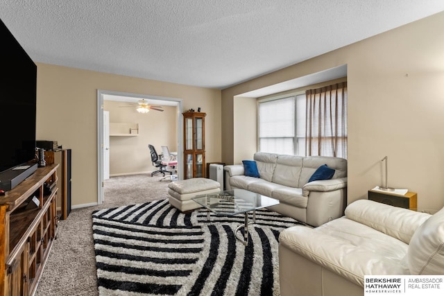 carpeted living room with ceiling fan, a textured ceiling, and radiator