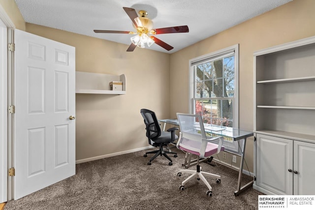 carpeted office space featuring ceiling fan and a textured ceiling