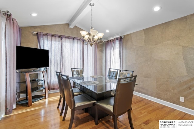 dining space with lofted ceiling with beams, light hardwood / wood-style floors, and a notable chandelier