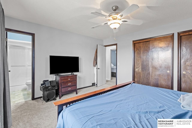 bedroom with connected bathroom, ceiling fan, light carpet, and a textured ceiling