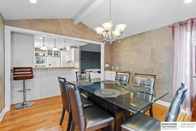 dining area with vaulted ceiling with beams, an inviting chandelier, and light hardwood / wood-style flooring