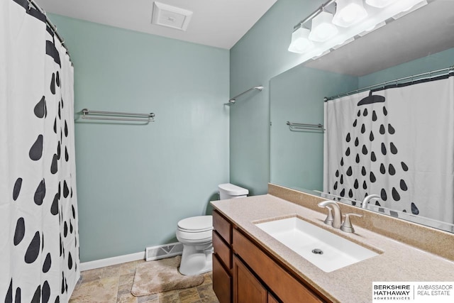 bathroom with vanity, a shower with shower curtain, and toilet