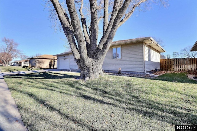 view of property exterior featuring a garage and a yard