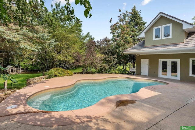 view of swimming pool with a patio area and french doors