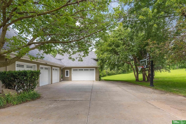 view of front facade with a garage and a front lawn