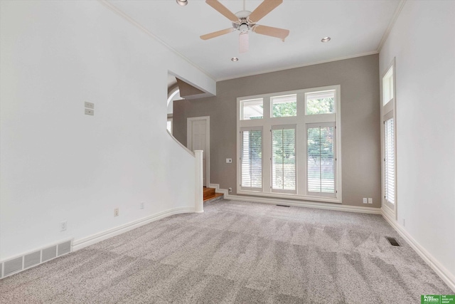 unfurnished living room featuring carpet, ceiling fan, and ornamental molding