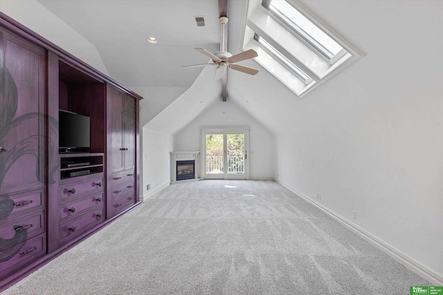 bonus room with light carpet, lofted ceiling with skylight, and ceiling fan