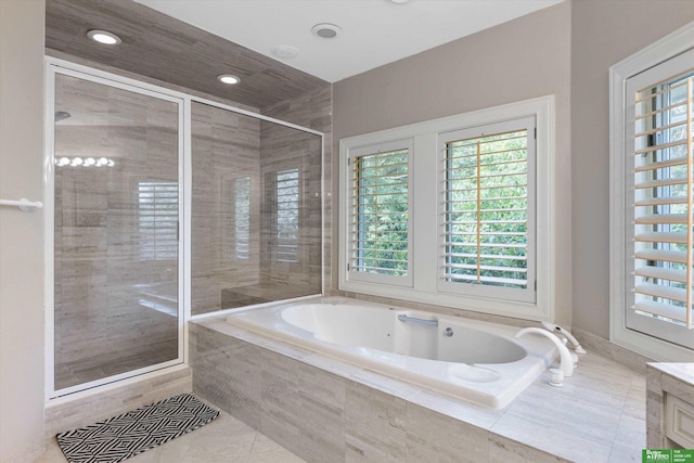 bathroom featuring plus walk in shower, tile patterned flooring, and vanity