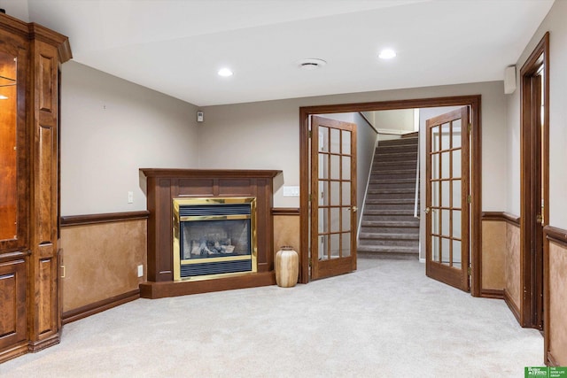 carpeted living room with french doors