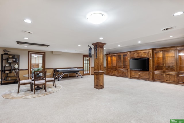 living room featuring french doors, light carpet, and decorative columns