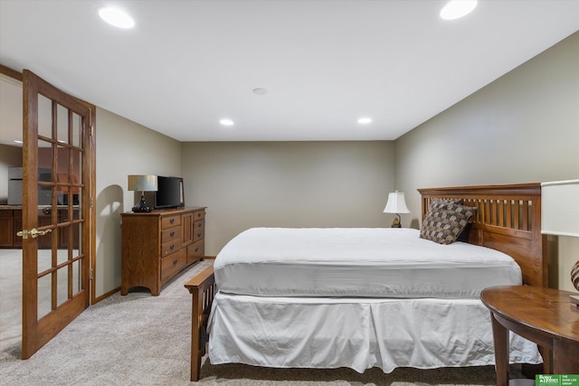 bedroom with french doors and light colored carpet