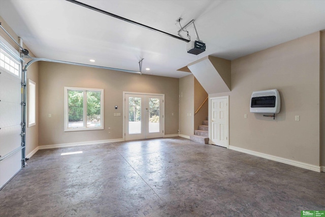 garage featuring heating unit, french doors, and a garage door opener