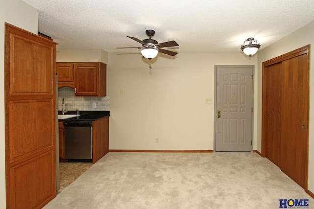 kitchen with dishwasher, sink, tasteful backsplash, a textured ceiling, and light carpet