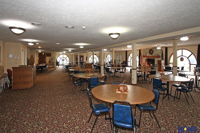 dining space with carpet flooring and a textured ceiling