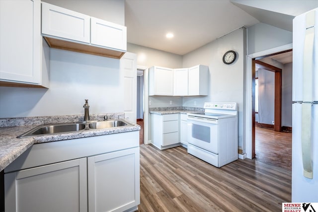 kitchen featuring hardwood / wood-style floors, white cabinetry, electric stove, and sink