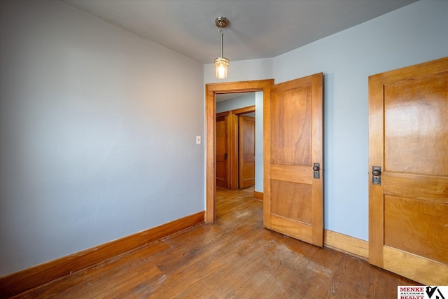 empty room with wood-type flooring