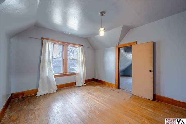 bonus room with lofted ceiling and wood-type flooring