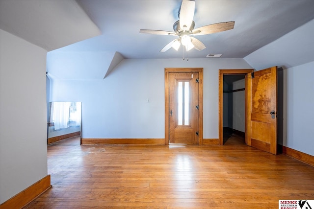 additional living space with ceiling fan, lofted ceiling, and light wood-type flooring