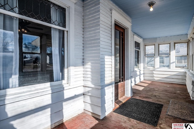 view of exterior entry with a porch