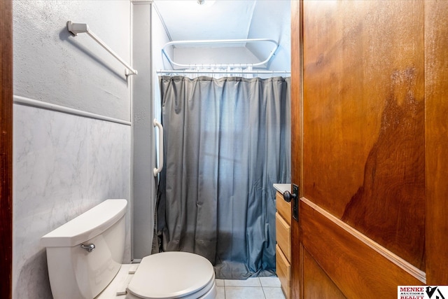 bathroom with tile patterned flooring and toilet