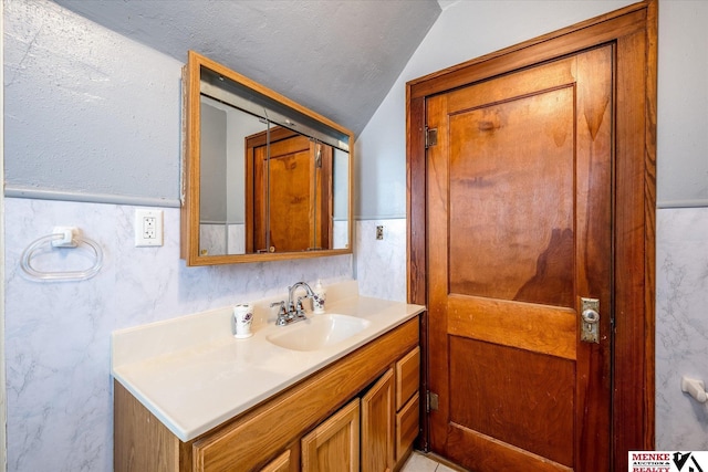 bathroom with vanity and lofted ceiling