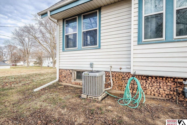 view of side of home featuring central AC unit