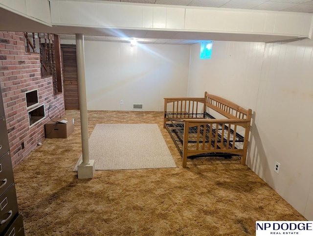 interior space featuring carpet and a brick fireplace