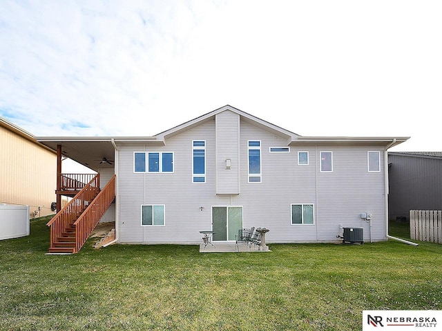 rear view of house featuring ceiling fan, a yard, central air condition unit, and a patio