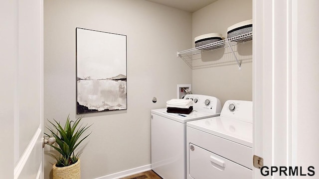 laundry room featuring wood-type flooring and washing machine and clothes dryer