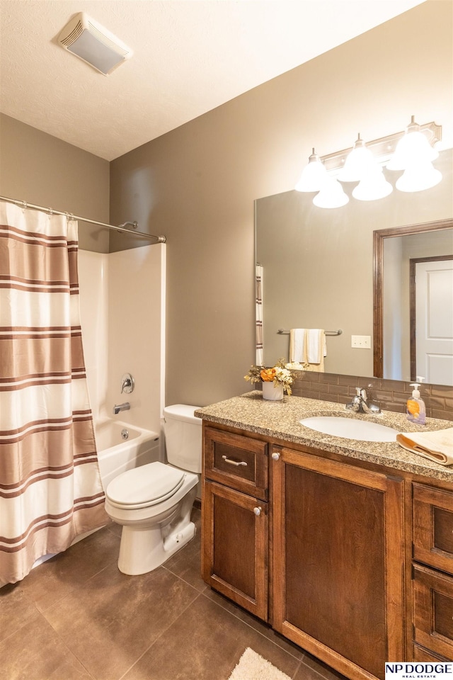 full bathroom featuring tile patterned floors, vanity, toilet, and shower / tub combo