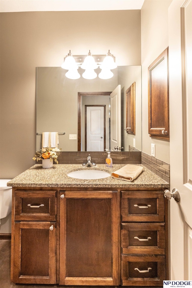 bathroom featuring vanity and toilet