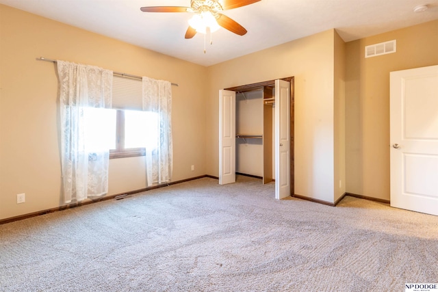 unfurnished bedroom with ceiling fan, light carpet, and a closet