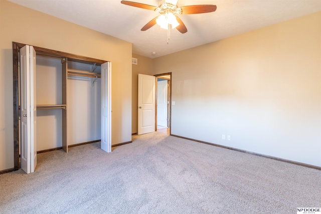 unfurnished bedroom with ceiling fan, light colored carpet, and a closet