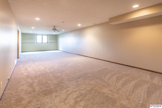 basement featuring ceiling fan and carpet