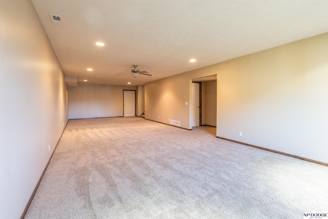 spare room with light colored carpet and ceiling fan