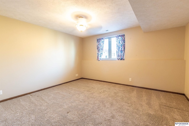 unfurnished room with carpet floors and a textured ceiling